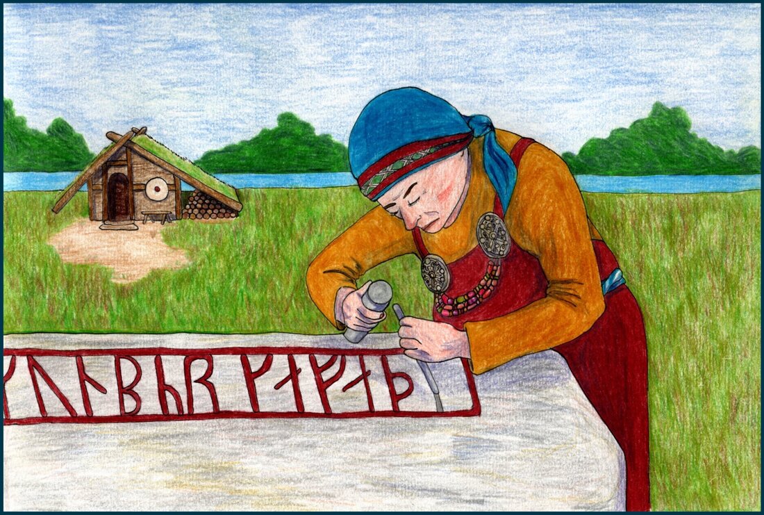 Picture. A middle-aged white woman is bent over a large stone slab. She is using a chisel to carve runes into the stone. The finished runes are painted red. She is wearing a Viking woman’s outfit with tortoise shell brooches, amber and glass bead necklaces, a red apron and a blue kerchief. Behind her along the waterfront is a small wooden house with a turf roof.